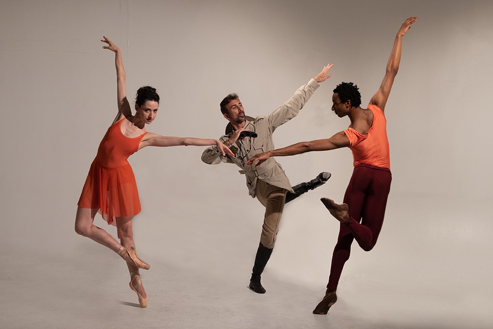 Three dancers flick a leg
